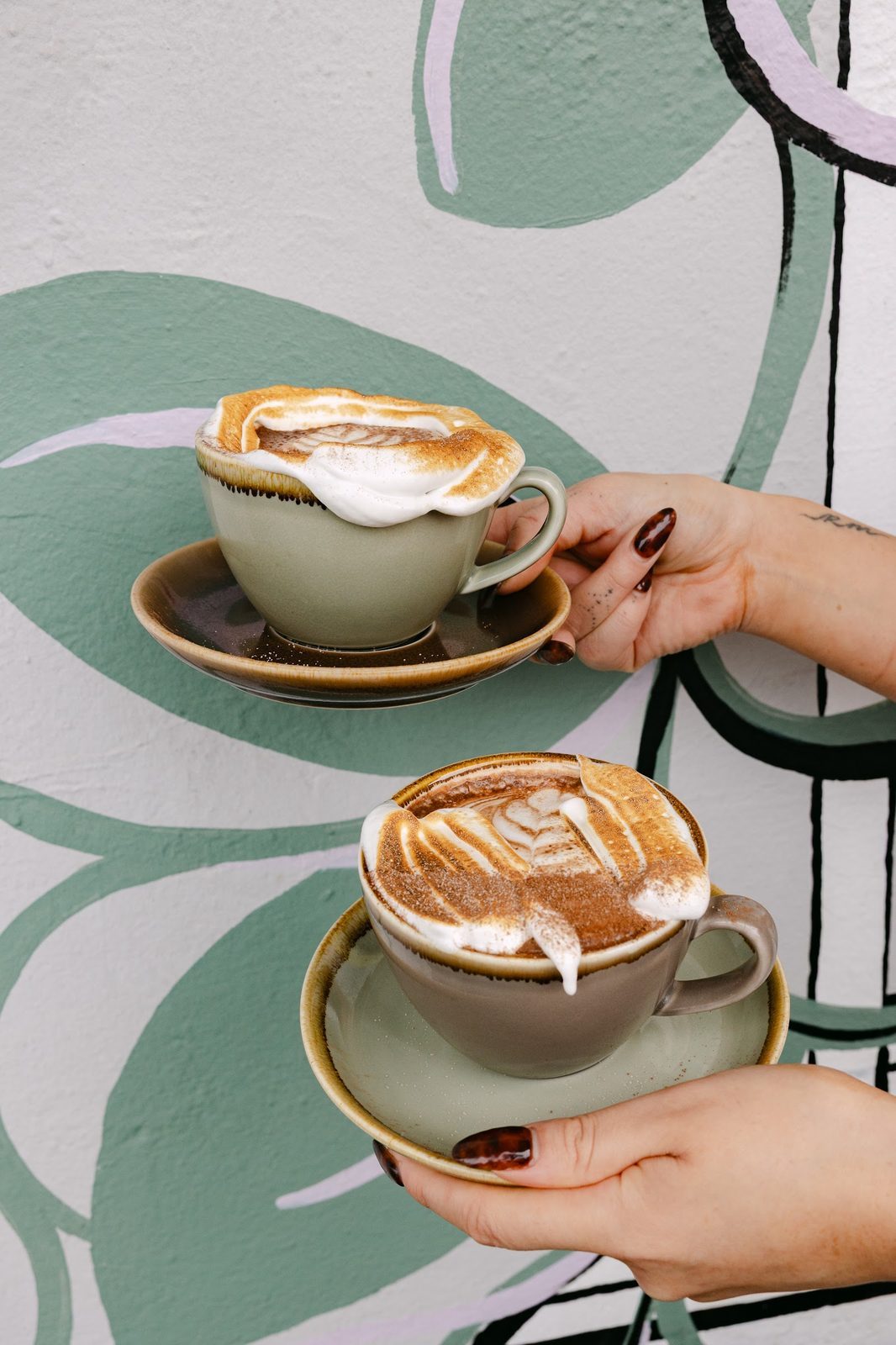 Nalou Kitchen teal cup with toasted marshmallow foam and cocoa dust